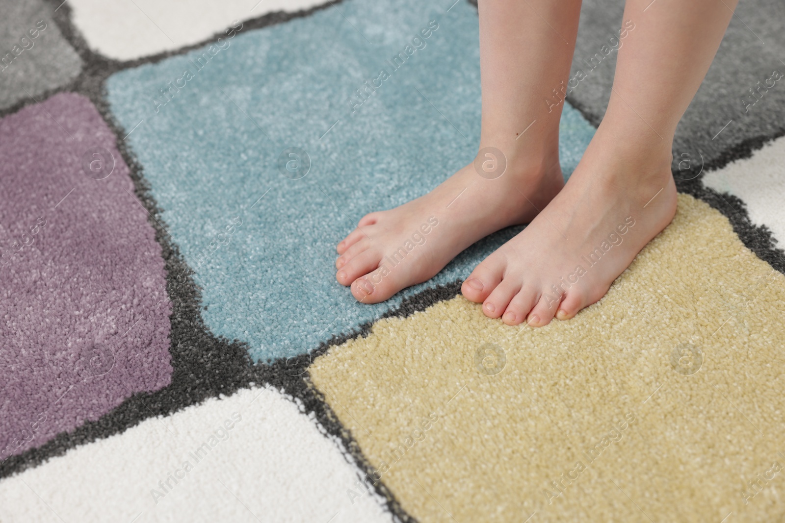 Girl on soft carpet at home, closeup Photo of Girl on soft carpet at home, closeup