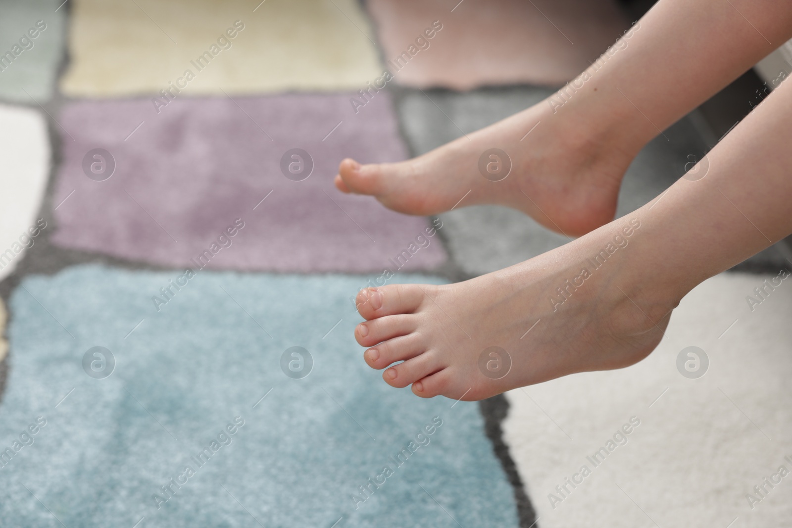 Girl above soft carpet at home, closeup Photo of Girl above soft carpet at home, closeup