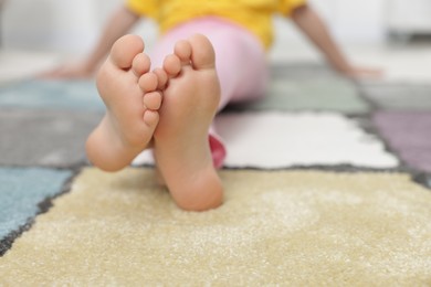 Photo of Girl on soft carpet at home, closeup