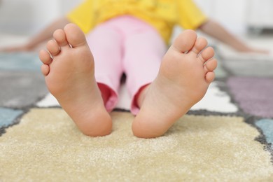 Photo of Girl on soft carpet at home, closeup