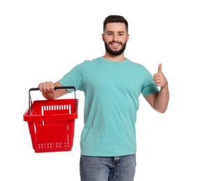 Photo of Man with empty shopping basket showing thumbs up on white background