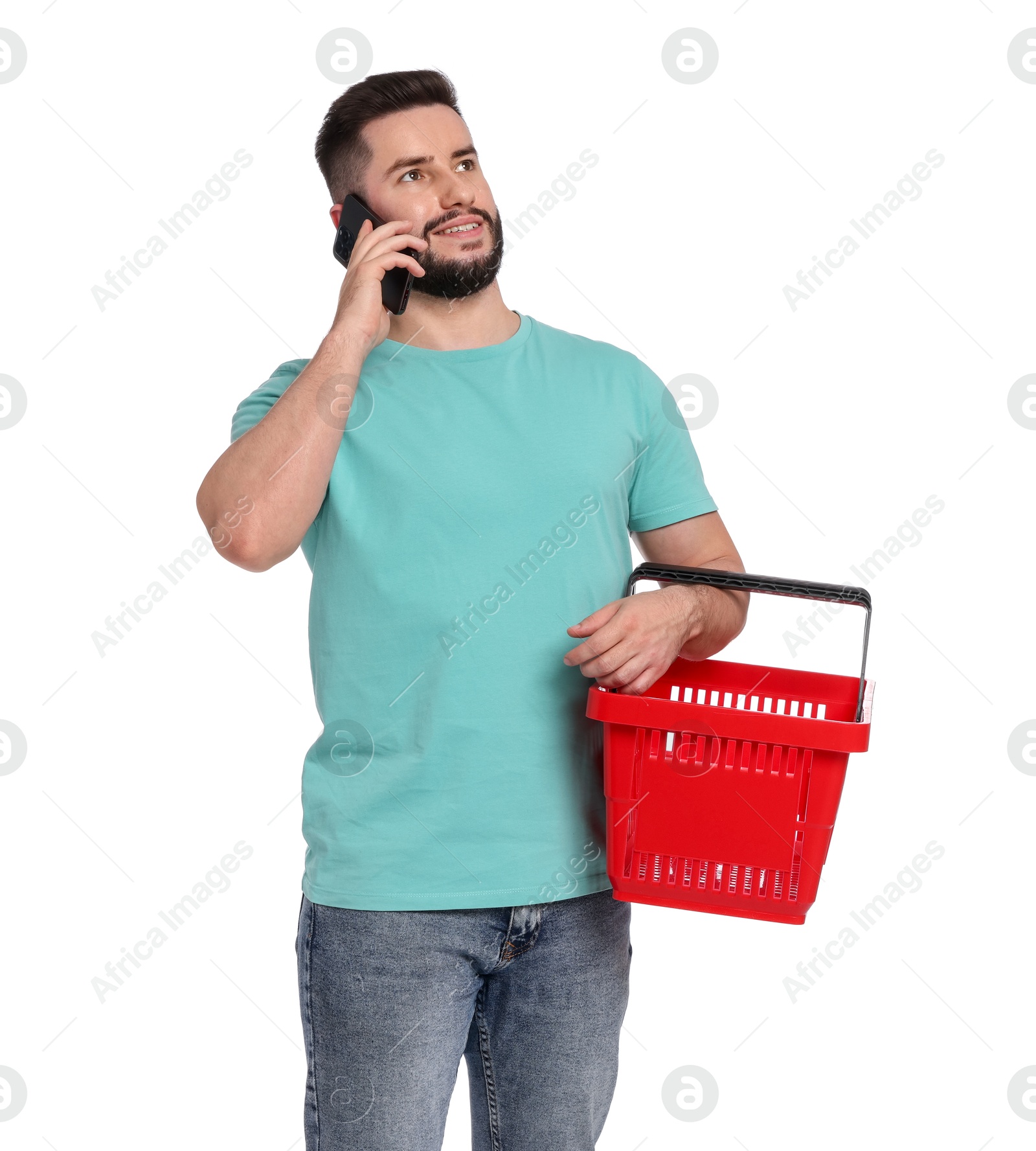 Man with empty shopping basket talking on smartphone against white background Photo of Man with empty shopping basket talking on smartphone against white background