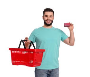 Photo of Man with empty shopping basket and credit card on white background