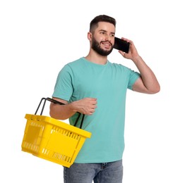 Photo of Man with empty shopping basket talking on smartphone against white background