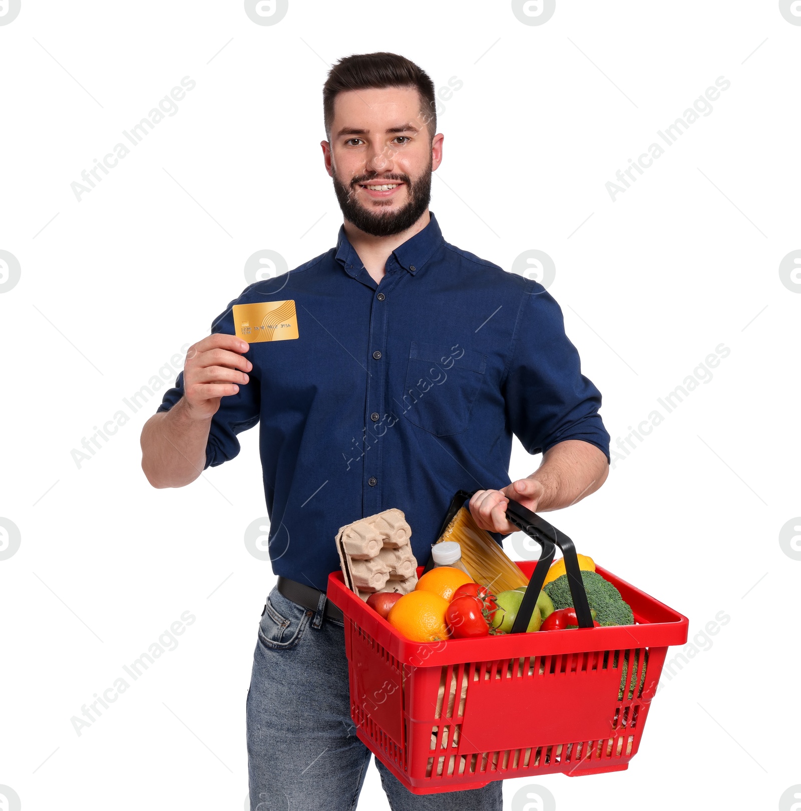 Man with shopping basket full of products and credit card on white background Photo of Man with shopping basket full of products and credit card on white background