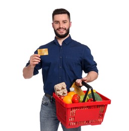 Photo of Man with shopping basket full of products and credit card on white background