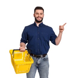 Photo of Man with empty shopping basket pointing at something on white background