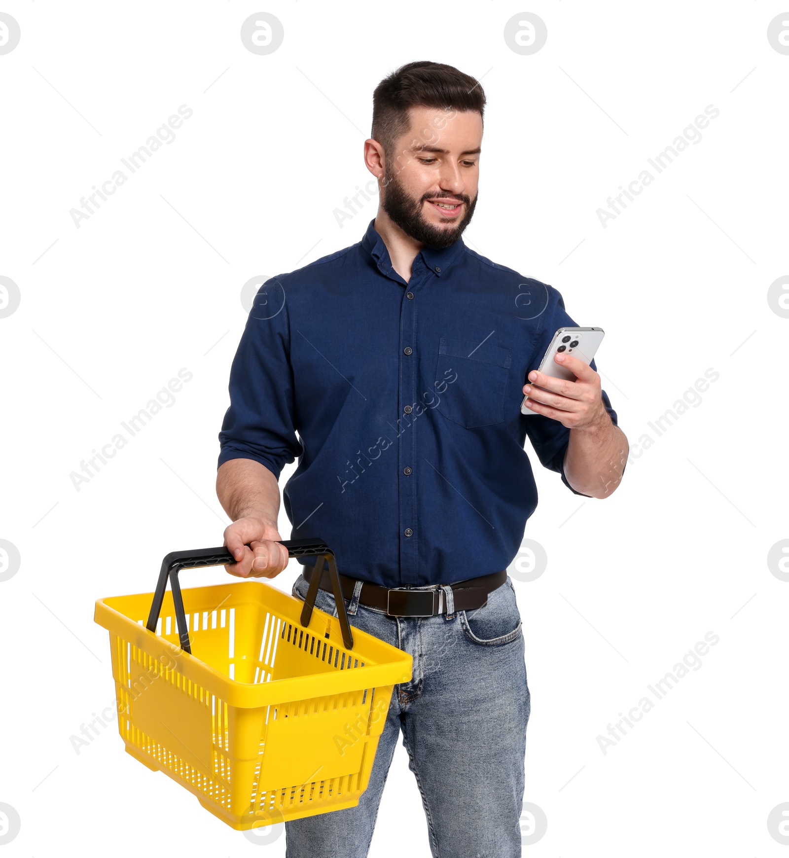 Man with empty shopping basket and smartphone on white background Photo of Man with empty shopping basket and smartphone on white background