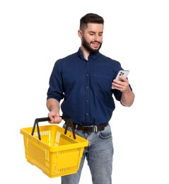 Photo of Man with empty shopping basket and smartphone on white background