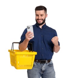 Photo of Man with empty shopping basket and smartphone on white background