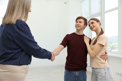 Photo of Real estate agent shaking hands with new owner at home