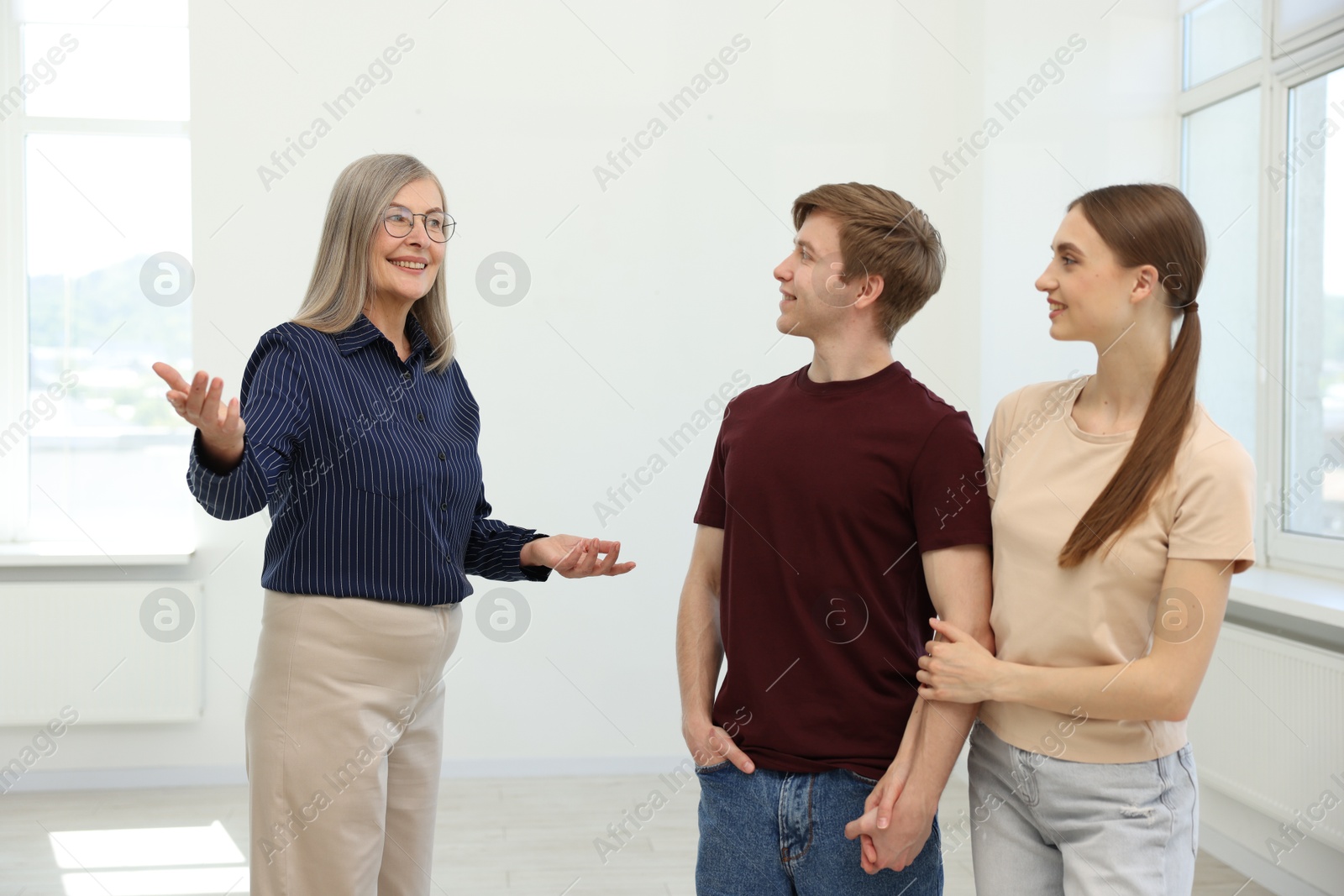 Smiling real estate agent working with couple at home Photo of Smiling real estate agent working with couple at home