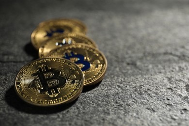 Photo of Cryptocurrency. Bitcoins on grey table, closeup. Space for text