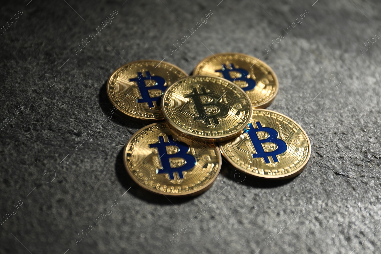 Cryptocurrency. Golden bitcoins on grey table, closeup Photo of Cryptocurrency. Golden bitcoins on grey table, closeup