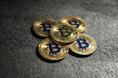 Photo of Cryptocurrency. Golden bitcoins on grey table, closeup