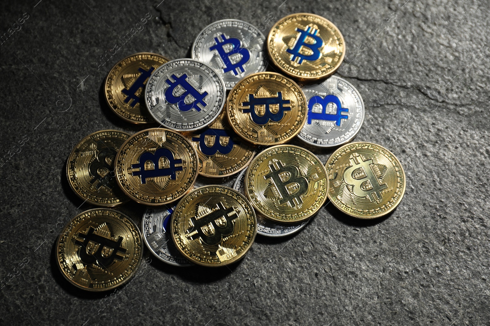 Cryptocurrency. Bitcoins on grey table, flat lay Photo of Cryptocurrency. Bitcoins on grey table, flat lay
