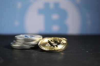 Photo of Cryptocurrency. Bitcoins on black table, closeup. Space for text