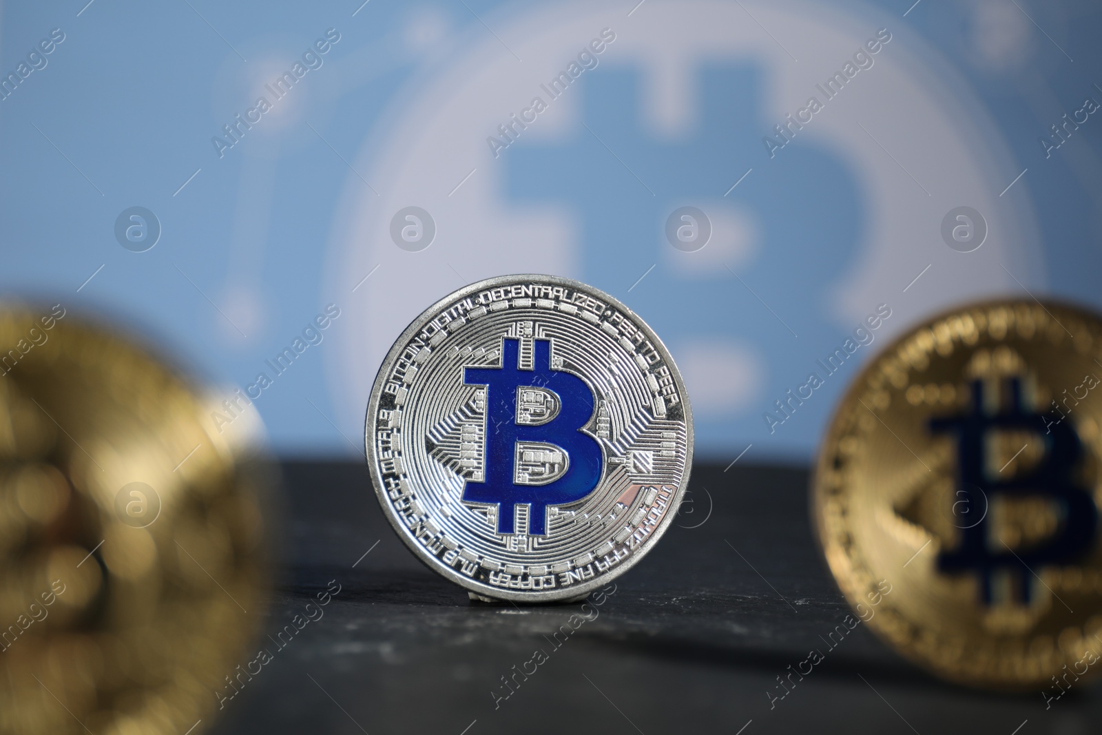 Cryptocurrency. Three bitcoins on black table, closeup Photo of Cryptocurrency. Three bitcoins on black table, closeup