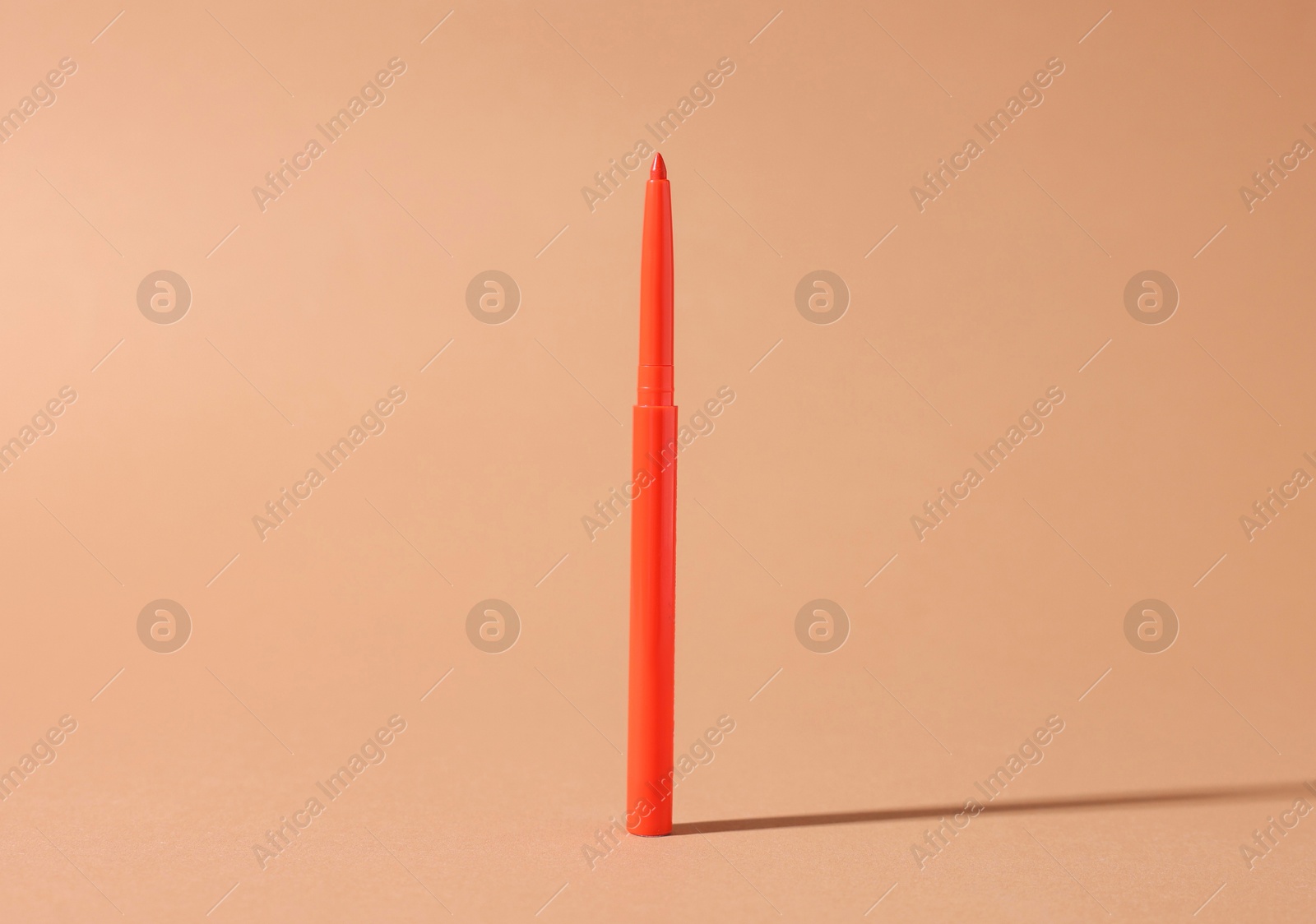 One twist up eye pencil on beige background, closeup Photo of One twist up eye pencil on beige background, closeup