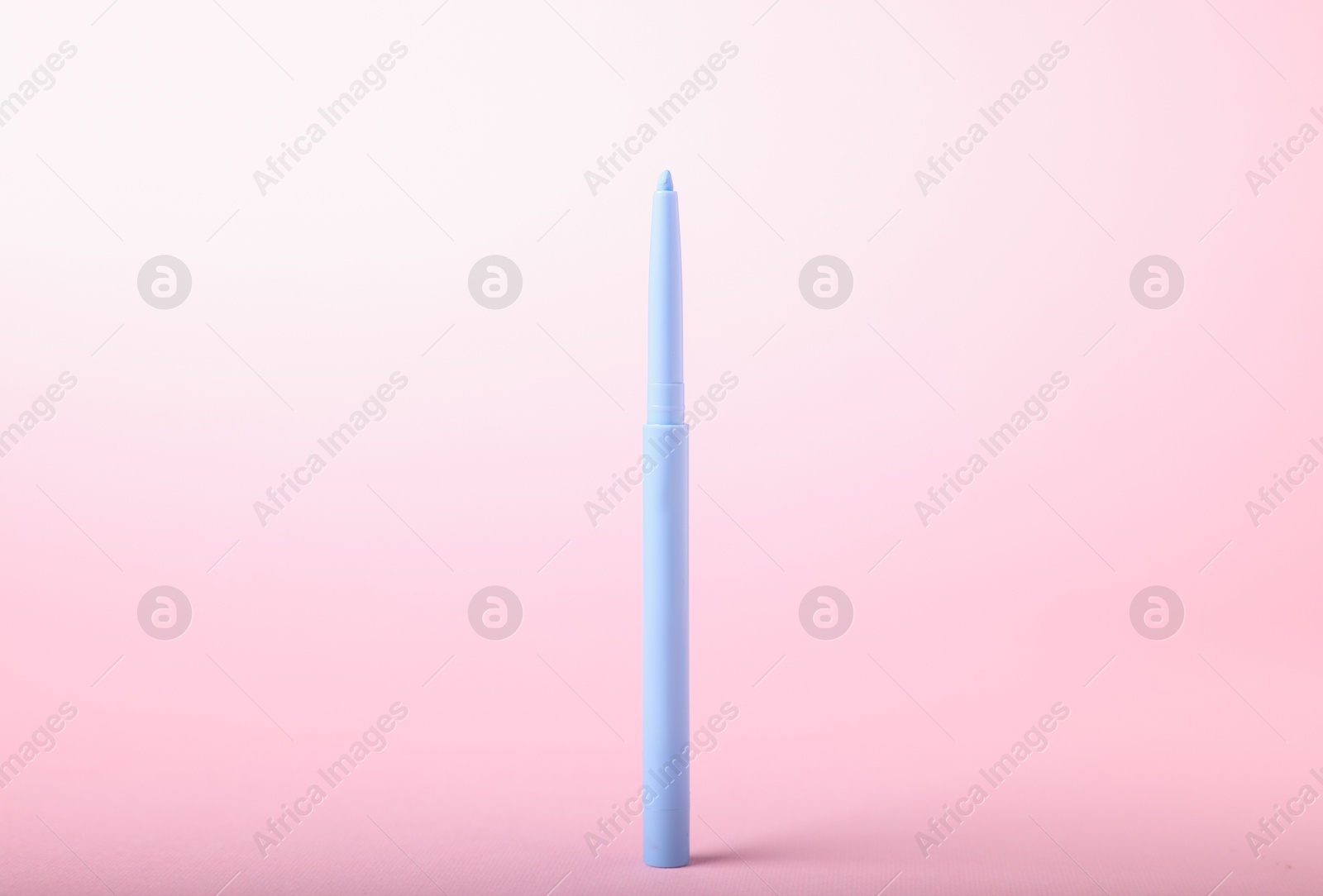 One twist up eye pencil on pink background, closeup Photo of One twist up eye pencil on pink background, closeup