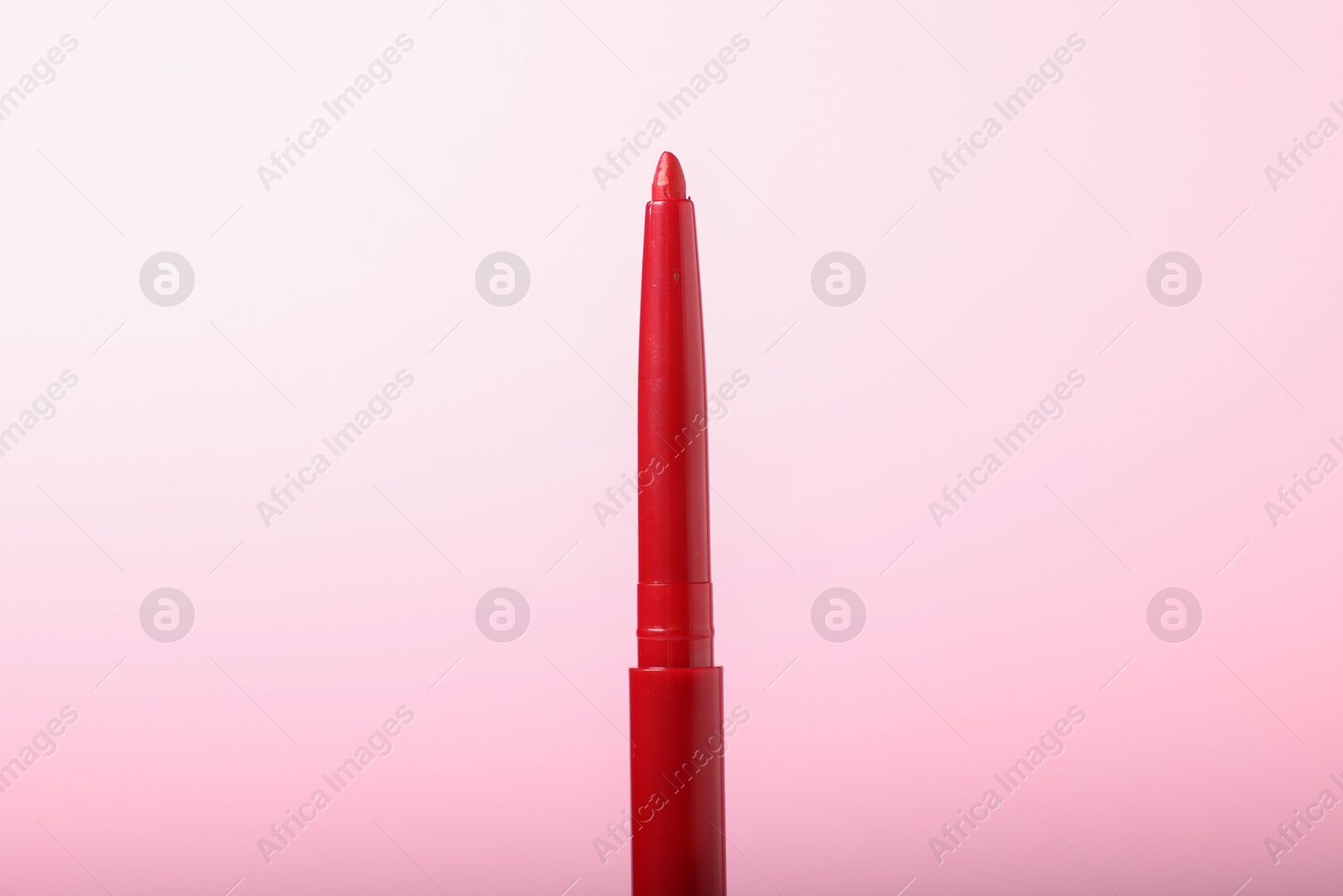 One twist up eye pencil on pink background, closeup Photo of One twist up eye pencil on pink background, closeup