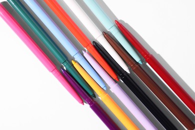 Photo of Colorful twist up eye pencils on white background, flat lay