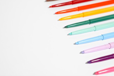 Photo of Colorful twist up eye pencils on white background, closeup. Space for text