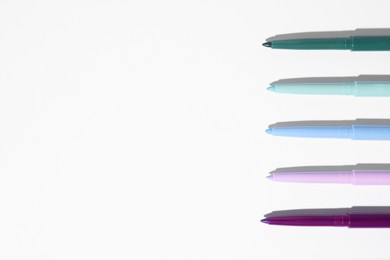 Photo of Colorful twist up eye pencils on white background, flat lay. Space for text