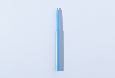Photo of One twist up eye pencil on white background, top view