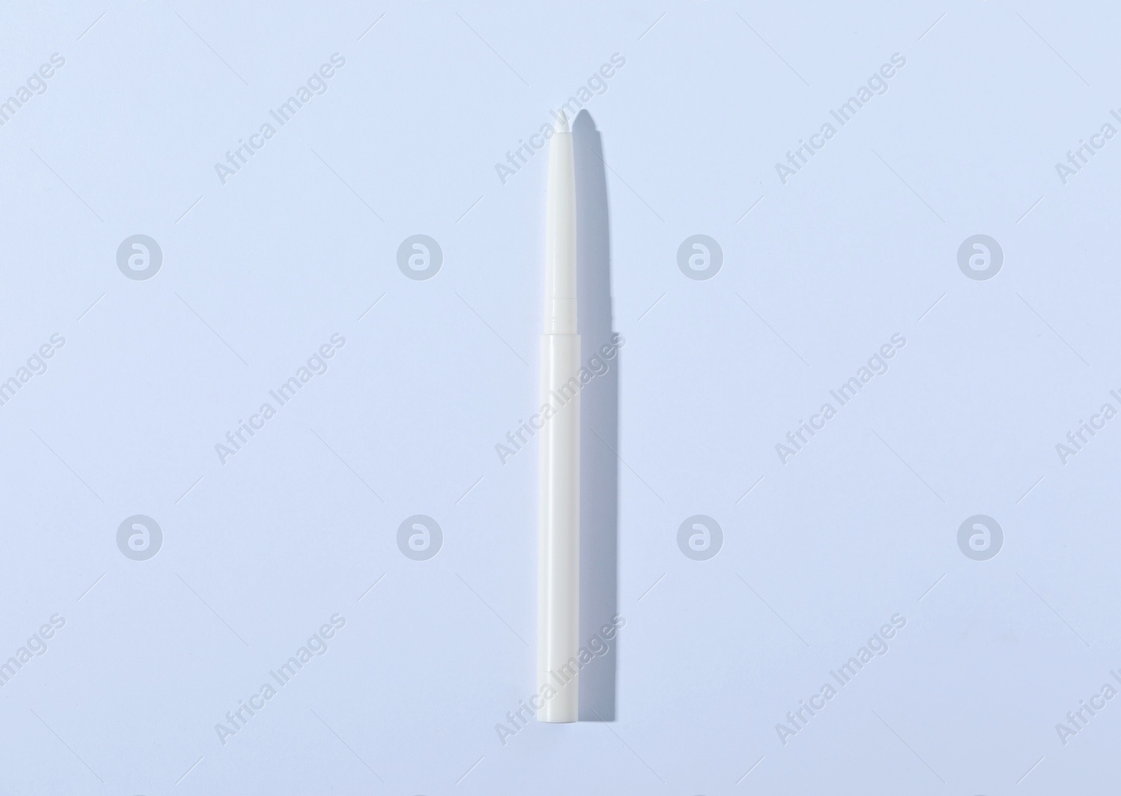 One twist up eye pencil on white background, top view Photo of One twist up eye pencil on white background, top view