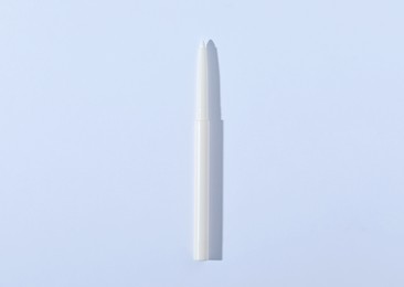 Photo of One twist up eye pencil on white background, top view