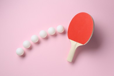 Photo of Ping pong racket and balls on pink background, flat lay