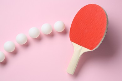 Photo of Ping pong racket and balls on pink background, flat lay