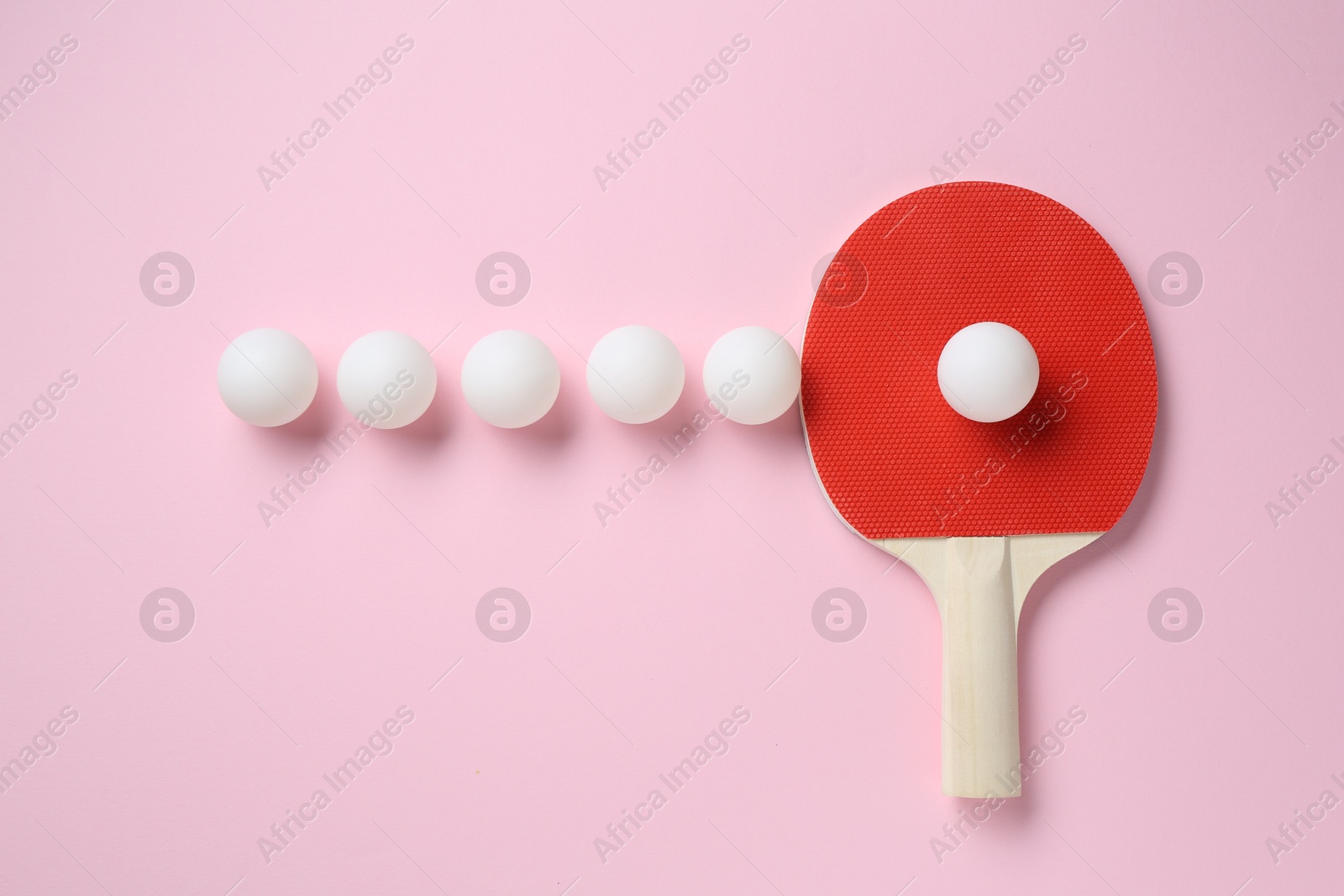 Ping pong racket and balls on pink background, flat lay Photo of Ping pong racket and balls on pink background, flat lay