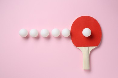 Photo of Ping pong racket and balls on pink background, flat lay