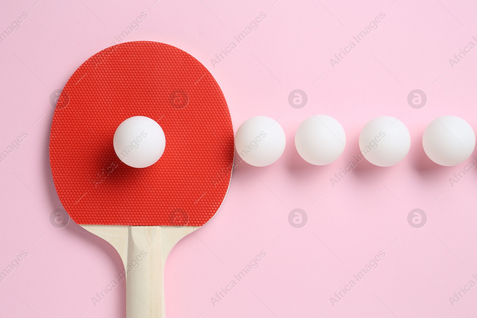 Ping pong racket and balls on pink background, flat lay Photo of Ping pong racket and balls on pink background, flat lay
