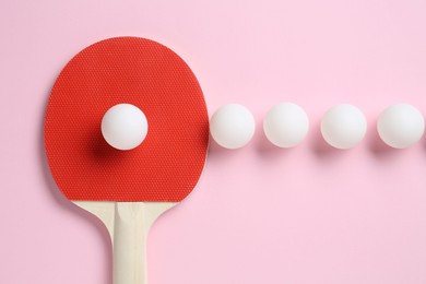 Photo of Ping pong racket and balls on pink background, flat lay