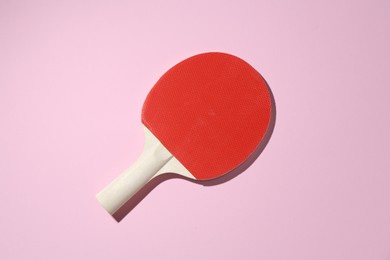 Photo of Ping pong racket on pink background, top view