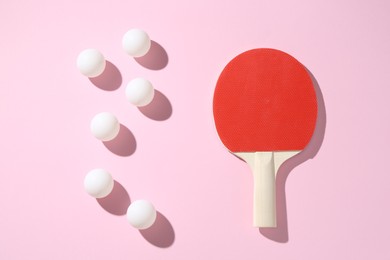 Photo of Ping pong racket and balls on pink background, flat lay