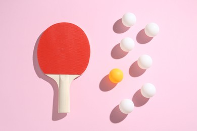 Photo of Ping pong racket and balls on pink background, flat lay