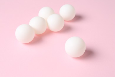 Photo of Many ping pong balls on pink background