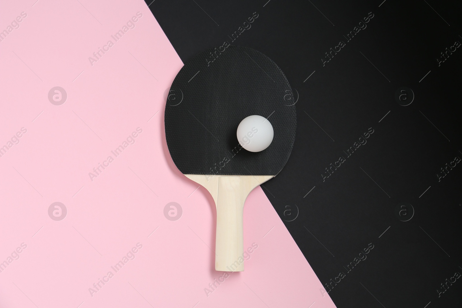 Ping pong racket and ball on color background, top view Photo of Ping pong racket and ball on color background, top view