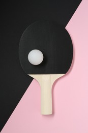 Photo of Ping pong racket and ball on color background, top view