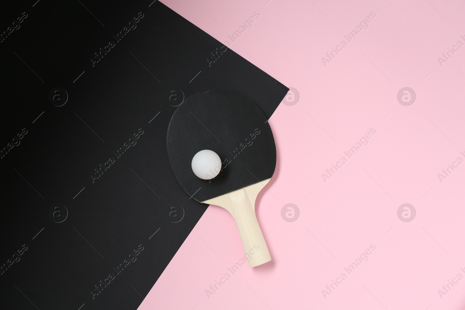 Ping pong racket and ball on color background, top view Photo of Ping pong racket and ball on color background, top view