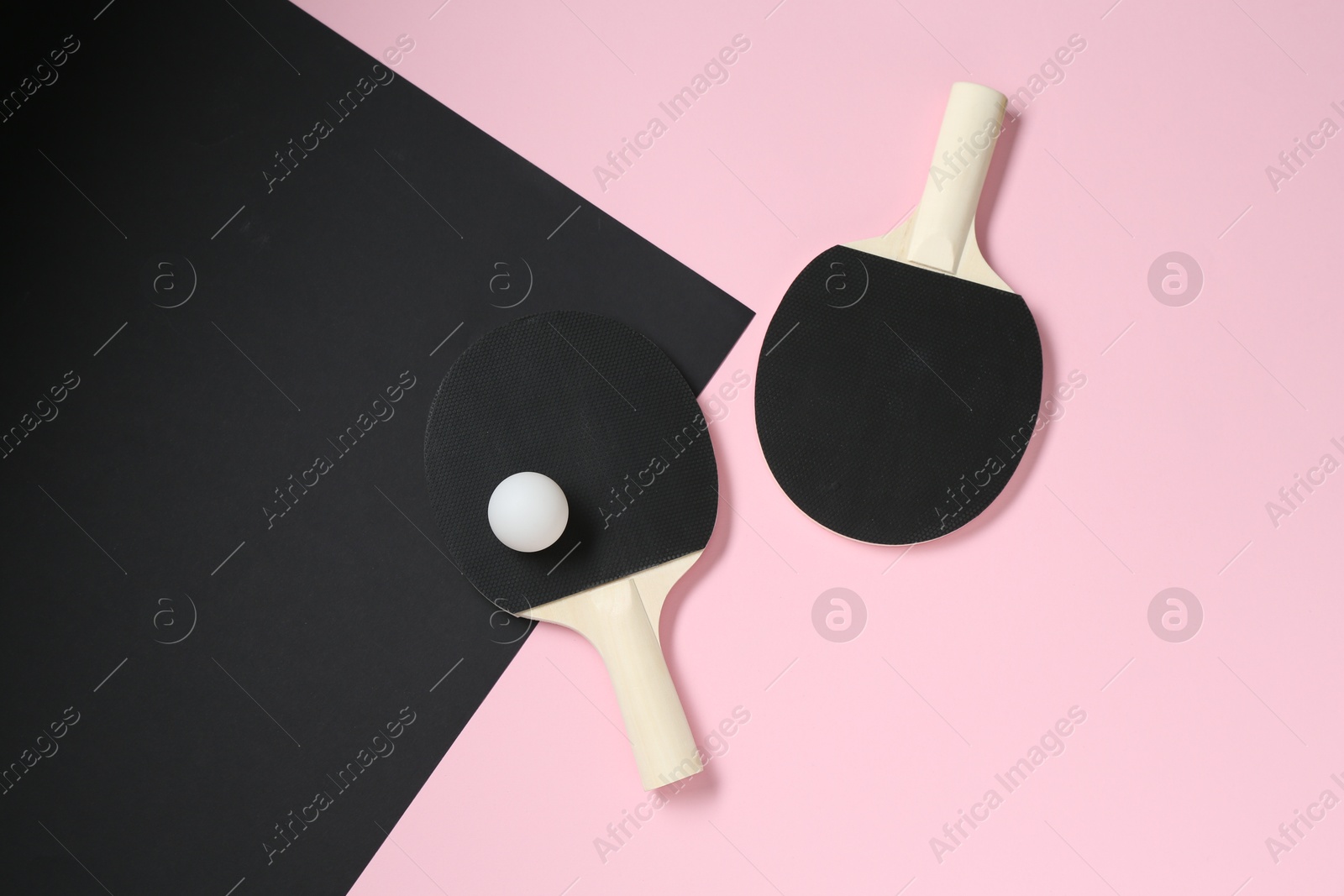Ping pong rackets and ball on color background, flat lay Photo of Ping pong rackets and ball on color background, flat lay