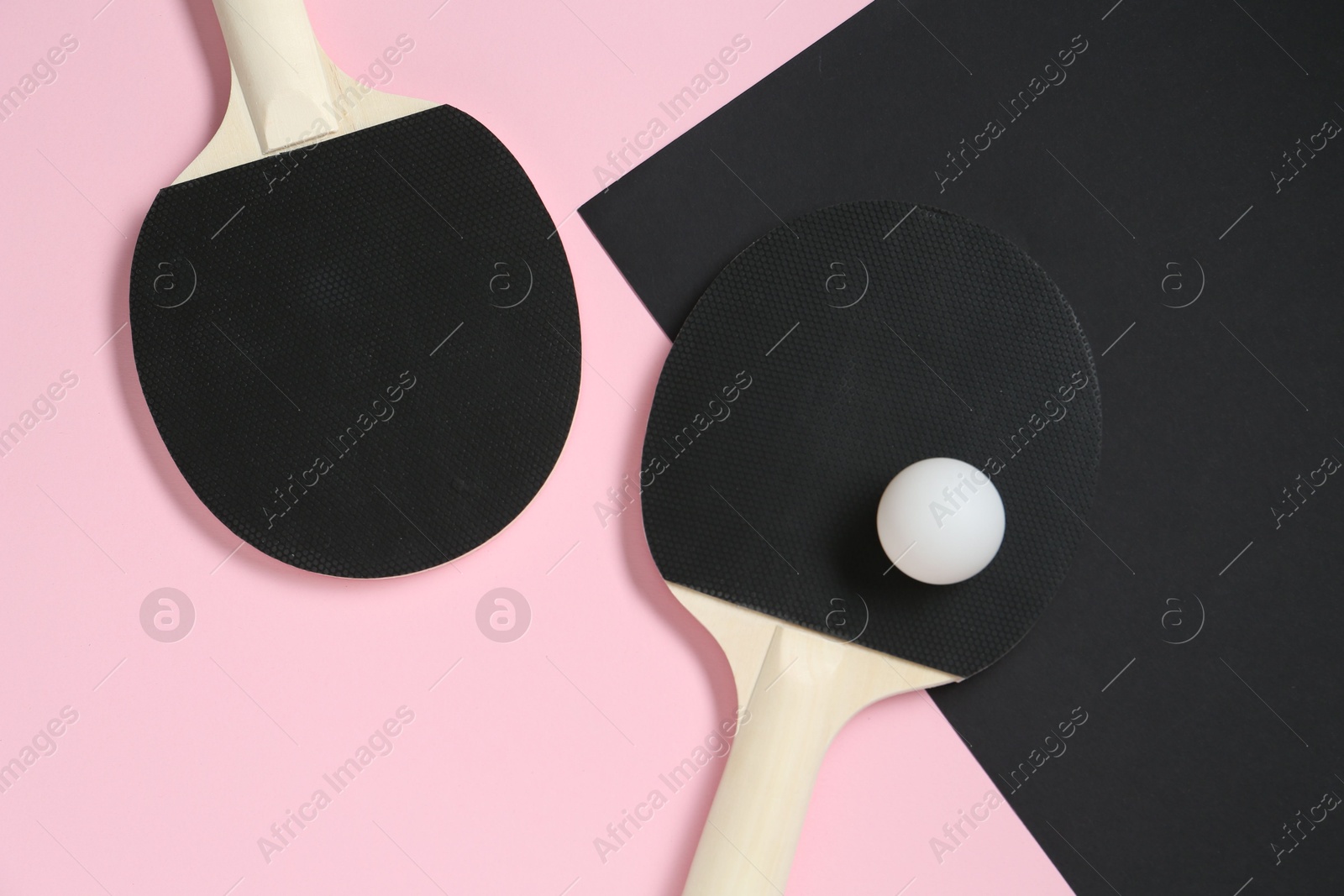 Ping pong rackets and ball on color background, flat lay Photo of Ping pong rackets and ball on color background, flat lay