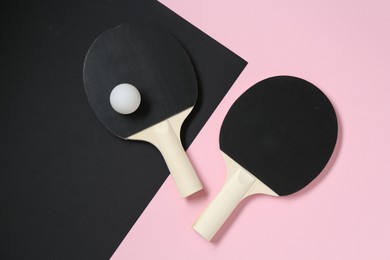Photo of Ping pong rackets and ball on color background, flat lay