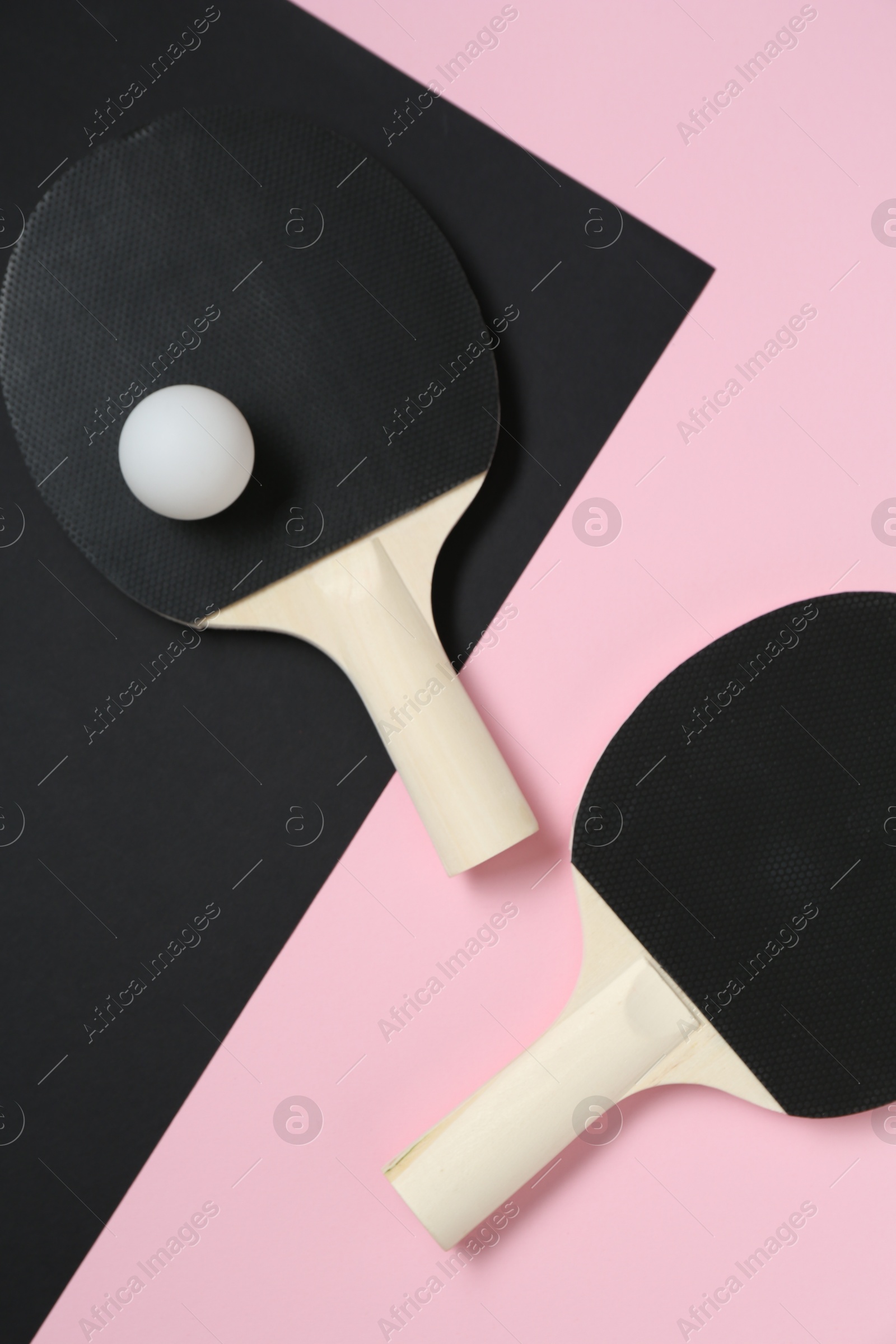 Ping pong rackets and ball on color background, flat lay Photo of Ping pong rackets and ball on color background, flat lay