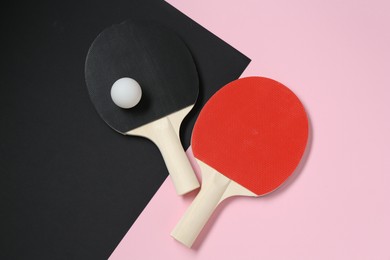 Photo of Ping pong rackets and ball on color background, flat lay