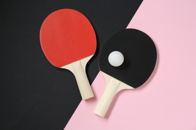 Photo of Ping pong rackets and ball on color background, flat lay
